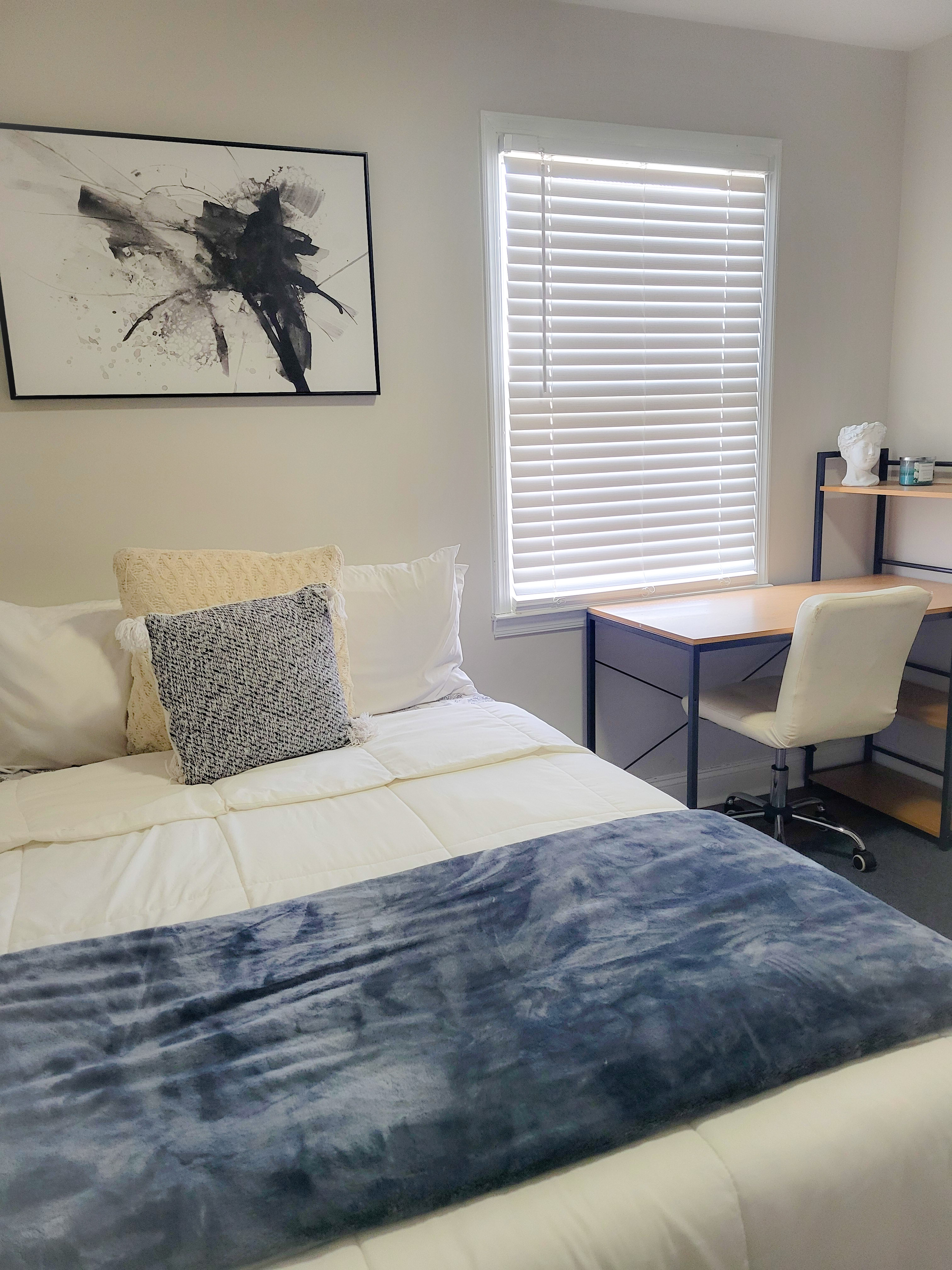 Room A bed and desk workspace